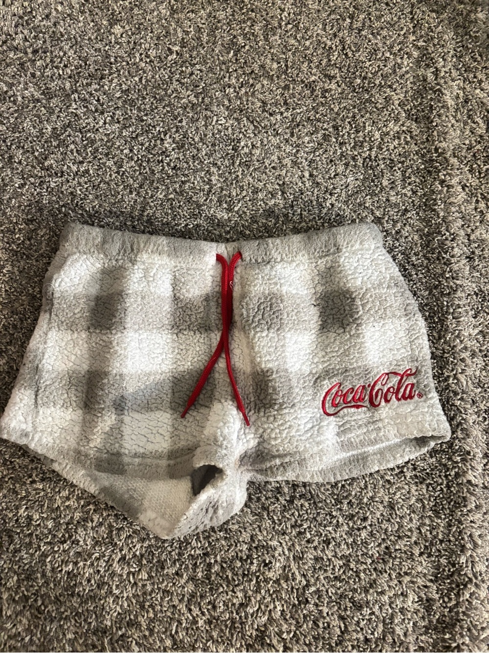 Coca-Cola Red Logo on Light Gray Knit Garment